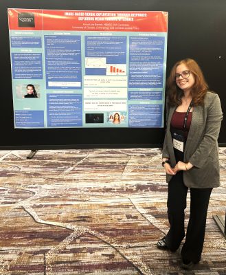 Anna-Lisa standing in front of her presentation poster