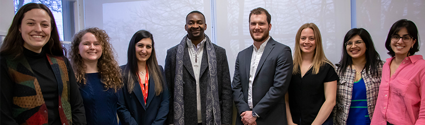 The alumni association executive poses with the Dean at an April 2023 meeting