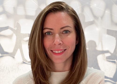 A headshot of Allison Reeves, a light-skinned woman with shoulder length brown hair and wearing a white crew-neck sweater, smiling at the camera.