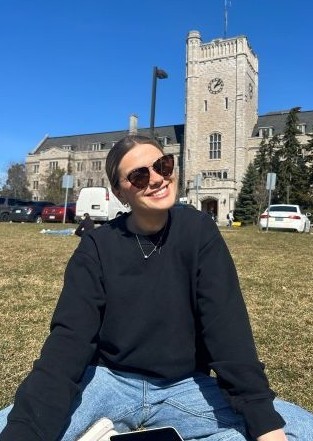 Julia smiling as she studies outside