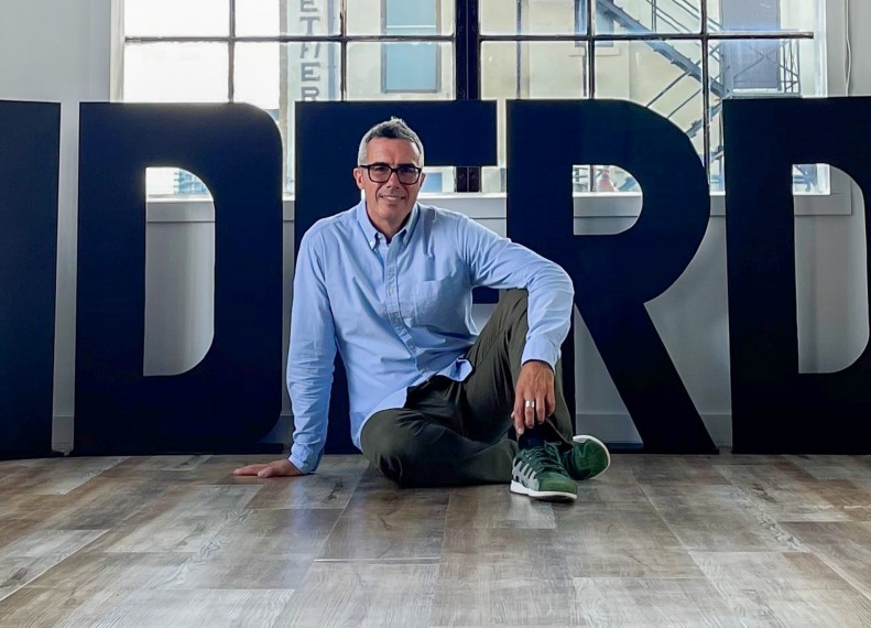 Francesco posing on the floor of a dance studio.