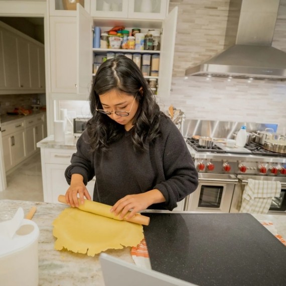 Sophia is rolling out some dough in her kitchen