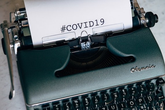 typewriter with #covid19 typed out