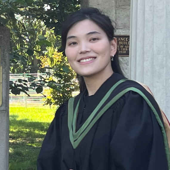 Tzu-Yi poses in front of the University of Guelph Portico wearing her graduation robes. 