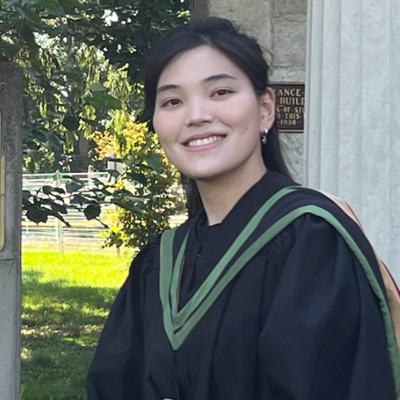 Tzu-Yi poses in front of the University of Guelph Portico wearing her graduation robes.