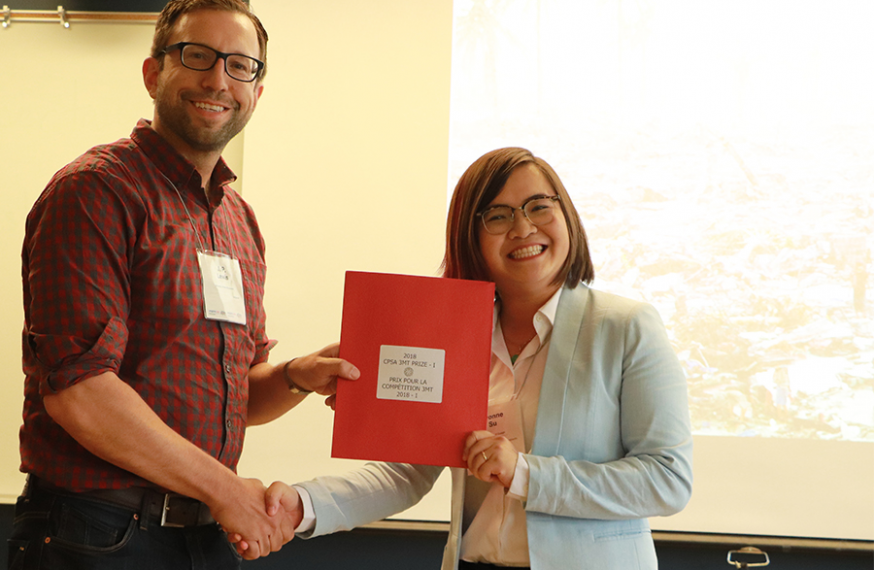 Yvonne Su being presented with award, shaking hands with the presenter