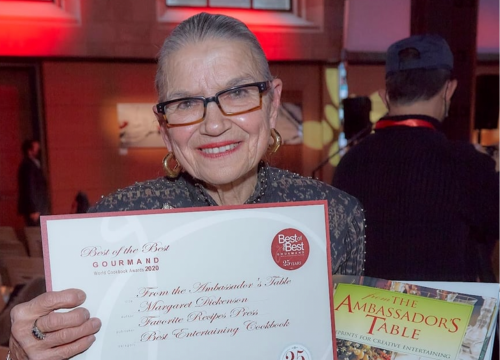 U of G alumna Margaret Dickenson holding an award in the Entertaining category at the Gourmand World Cookbook Awards in 2021.