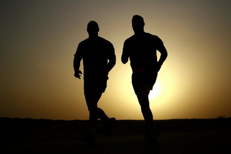 Two men are out running in the early morning 